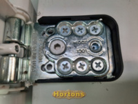 Exposing the adjusting screws on a uPVC door hinge